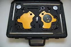 A black case with two yellow and black tools in it.