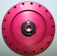 A pink disc with holes and a black center.